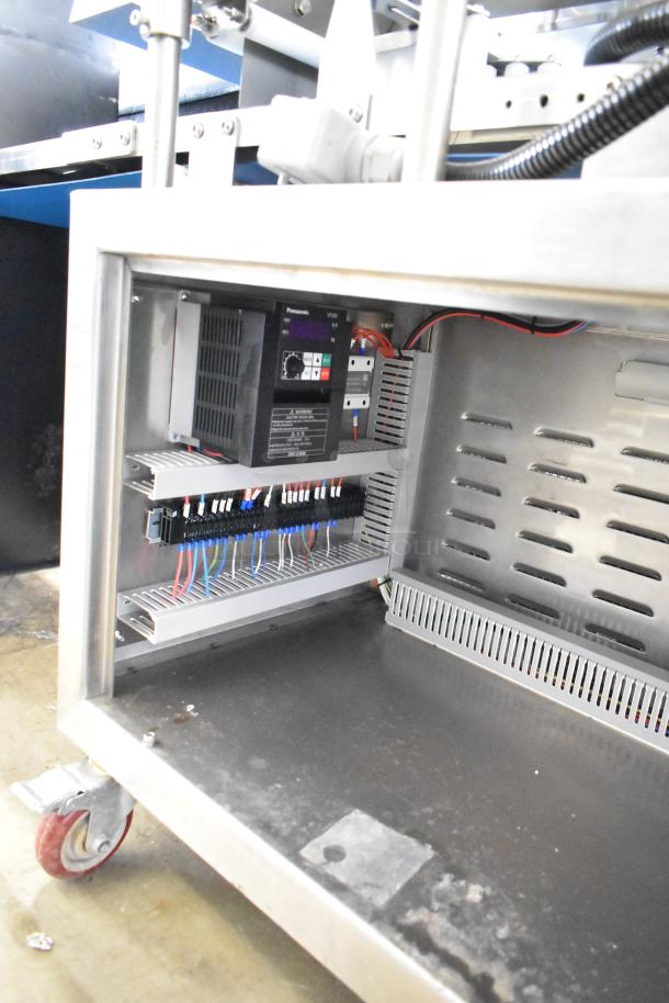 Seny Machinery commercial slicer and conveyor on casters, 220 volts. Features visible interior wiring and control panel.