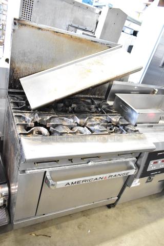 American Range commercial 6 burner gas range with oven, over shelf, and back splash. Appears used with visible wear.