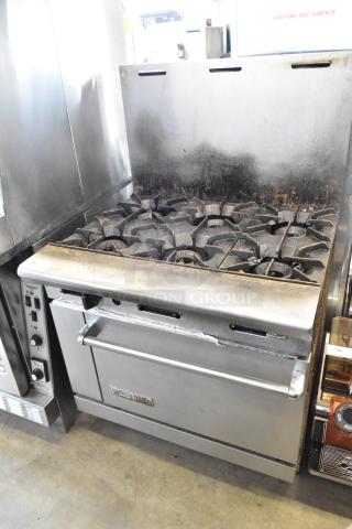 American Range commercial gas-powered six-burner range with oven and backsplash, stainless steel, used condition.