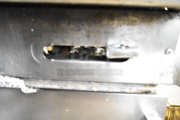 American Range commercial 6-burner gas range with oven, featuring backsplash and metal surface, showing signs of use.