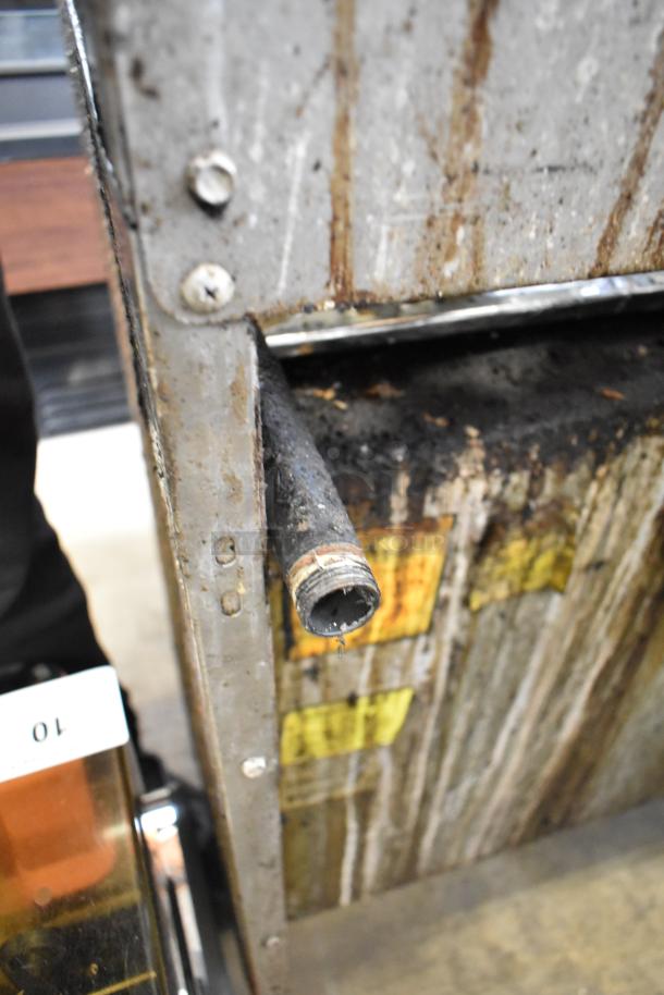 American Range commercial 6 burner gas range with oven and back splash. Worn condition, visible wear and labels.