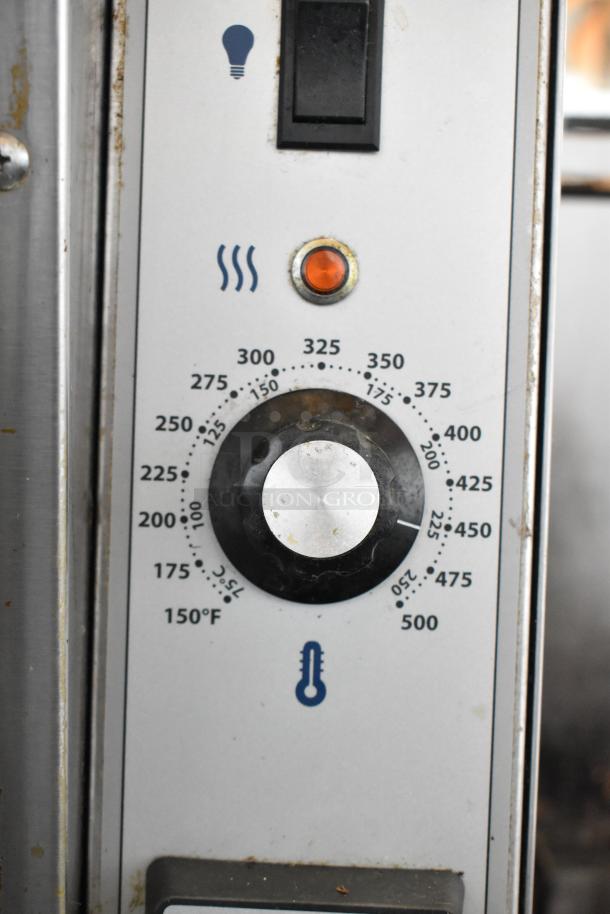 Close-up of Garland MCO-GS-10S convection oven controls, featuring thermostat dial and indicator lights, in used condition.