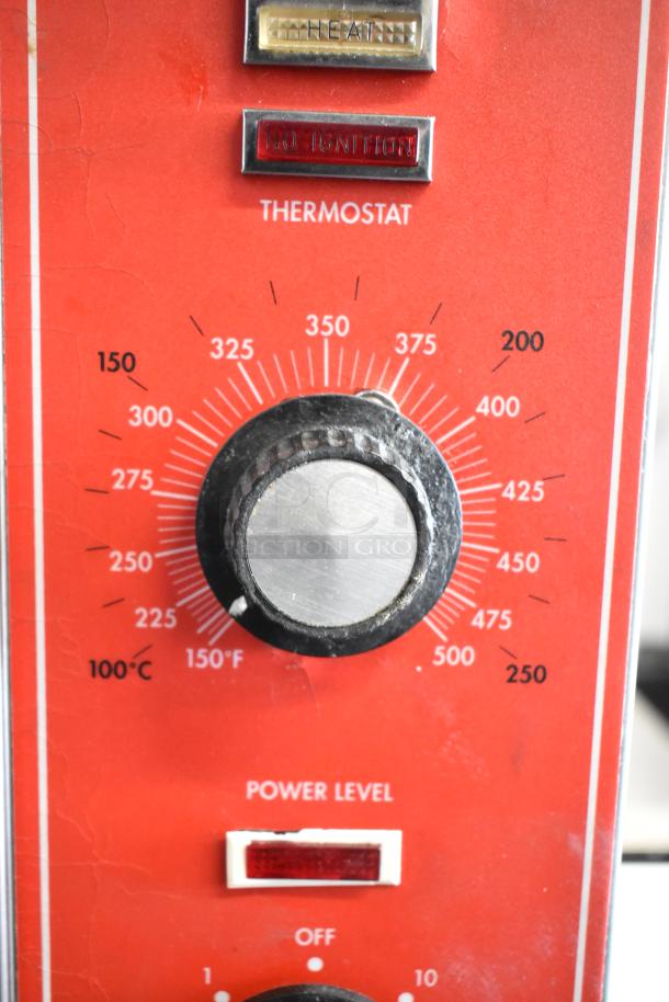 "Vulcan SG4D oven controls with temperature and power level knobs, clear labels for heat and ignition functions."