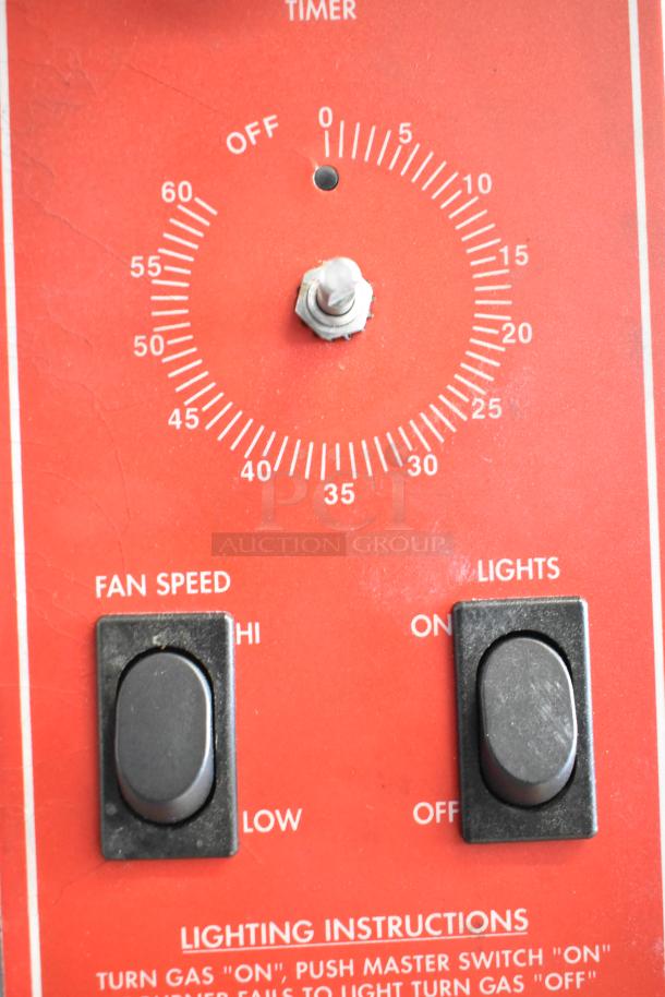 Turn dial and switches on Vulcan SG4D convection oven control panel, featuring timer and fan speed settings, in used condition.