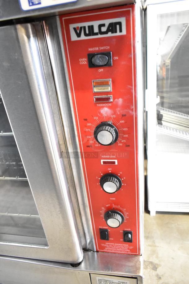 2 Vulcan SG4D gas convection ovens, view-through doors, thermostatic controls, robust red control panel, commercial-grade.
