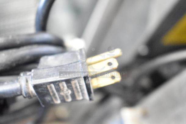 Close-up of a plug from the Vulcan SG4D commercial oven, showing a detailed view of its prongs and wiring.