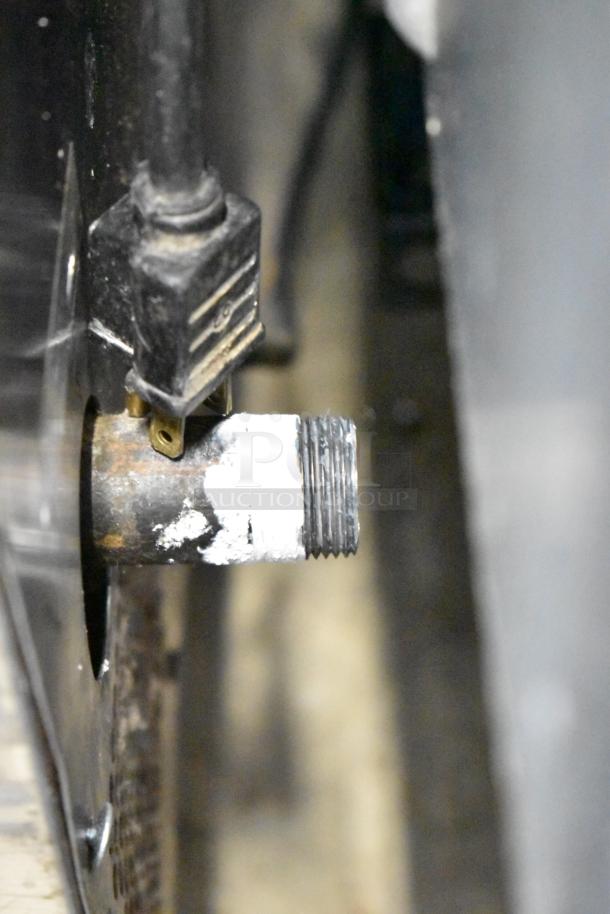 Gas connection detail of Vulcan SG4D commercial convection oven, showing pipe and fitting for gas supply.