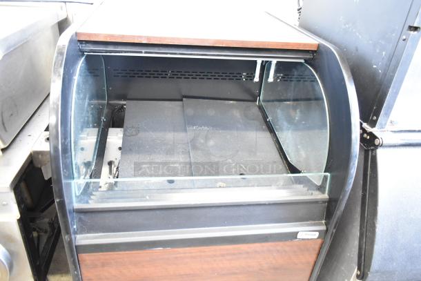 Structural Concepts Oasis CO2739R Grab N Go Merchandiser, 120V, 1 Phase, features curved glass, wood accents, and black finish.