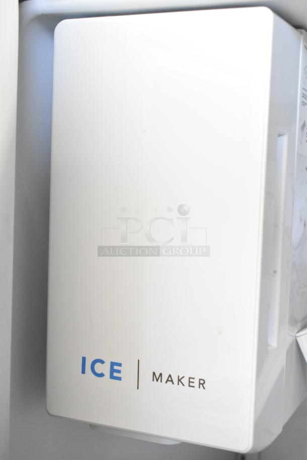 Frigidaire FRFC2323ASB ice maker, white with "ICE MAKER" label. Part of a brand new reach-in cooler.
