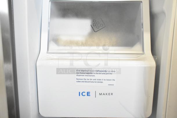 BRAND NEW 2025 Frigidaire FRFC2323ASB cooler with freezer, ice/water dispenser. Visible ice maker indicator and usage instructions.