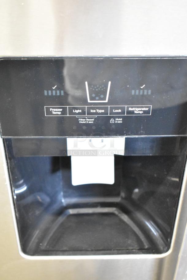 Close-up of Whirlpool WRS321SDHZ00 cooler’s ice/water dispenser panel, black with control buttons; brand new condition.