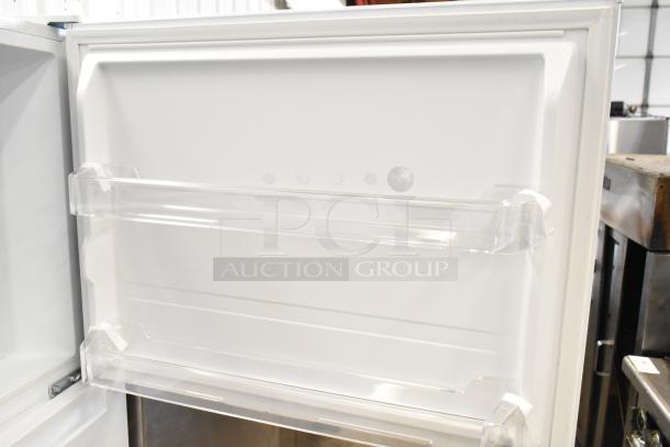 BRAND NEW SCRATCH AND DENT 2025 Vissani MDTF18WHR5 cooler door interior with clear storage shelves visible.