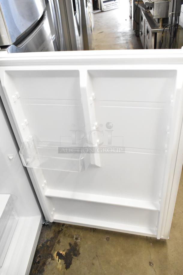 Brand new Vissani MDTF18WHR5 reach-in cooler with freezer, 115V, 1-phase. Interior view showing door storage.