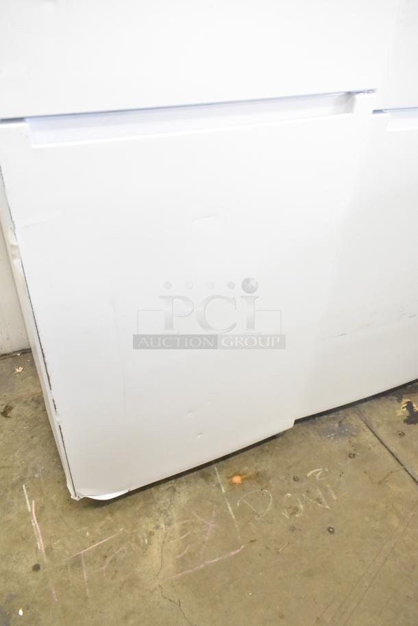 Brand new Vissani MDTF18WHR reach-in cooler with dents. Features freezer, 115V, 1 phase. Visible scratches and damage.