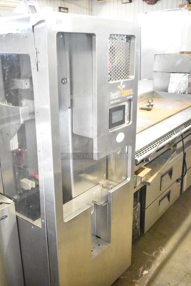 Late model JBT 2ND-GEN-MFJ-HE citrus juicer, stainless steel, "Fresh N Squeeze" label, on commercial casters, 115V, 1 phase.