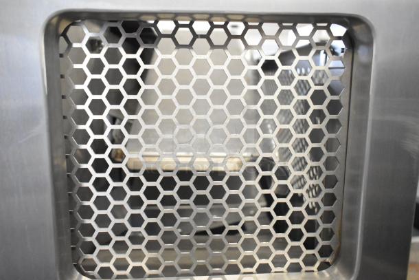 Hexagonal metal grate of JBT 2nd-Gen-MFJ-HE Citrus Juicer. Durable stainless steel. Ideal for commercial use.
