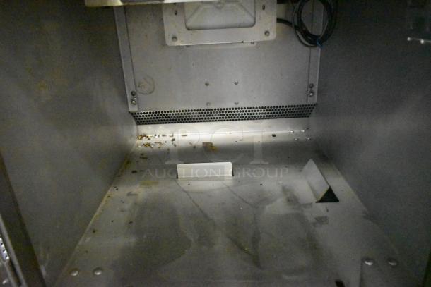 LATE MODEL! JBT 2ND-GEN-MFJ-HE citrus juicer interior view, showing metal casing with minor residue.