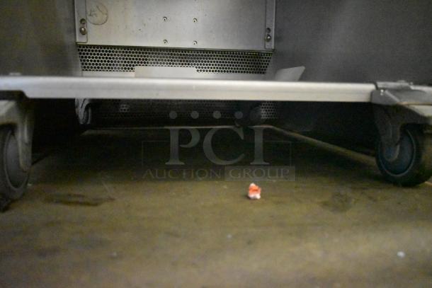 JBT 2ND-GEN-MFJ-HE citrus juicer on commercial casters, steel frame visible, 115V, 1 Phase, late model condition.