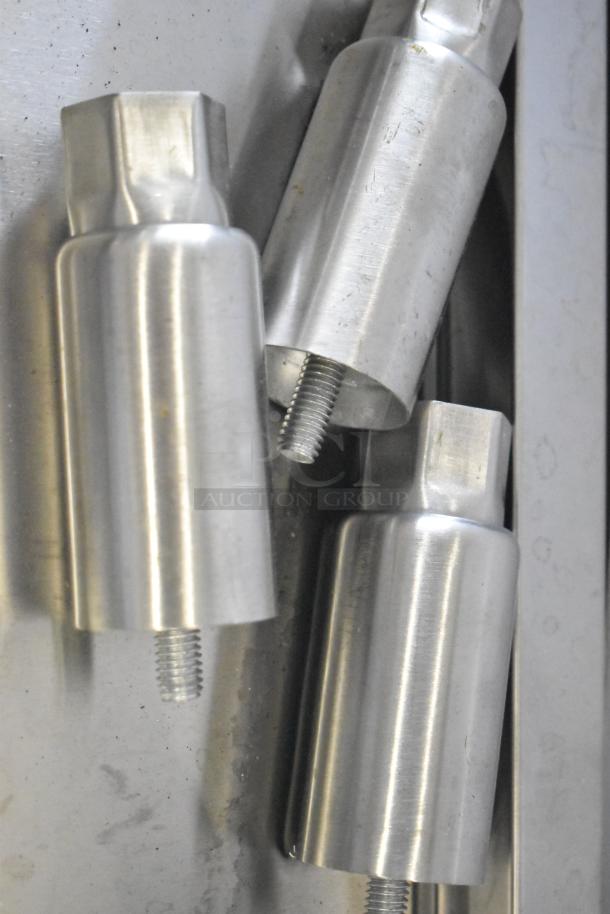 Four metal legs for the 2025 Cooking Performance Group 4 Burner Range. Sturdy construction, shows available fittings.