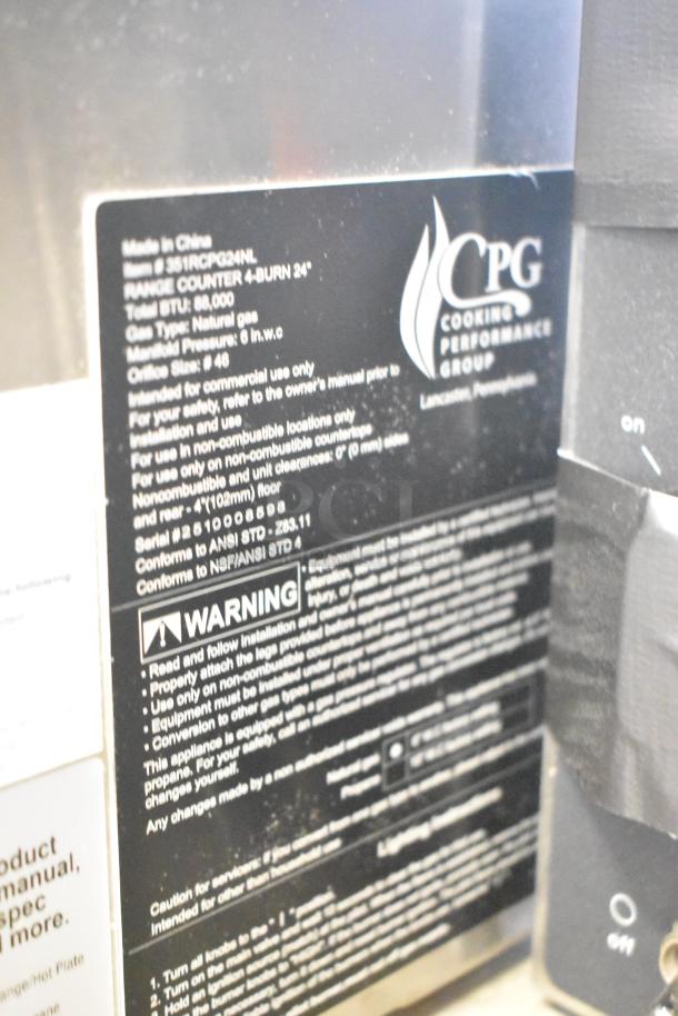 "Brand new 2025 Cooking Performance Group R-CPG-24-NL 4 burner natural gas range, 88,000 BTU. Black label displays specs."