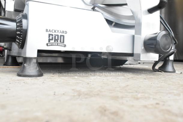 2021 Backyard Pro 554SL112E Butcher Series meat slicer, 12" blade, gravity feed, manual, 120V, with blade sharpener, visible logo.