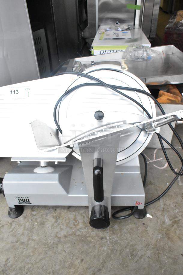 2021 Backyard Pro 554SL112E meat slicer, 12" blade, manual gravity feed, blade sharpener, good condition, 120V.