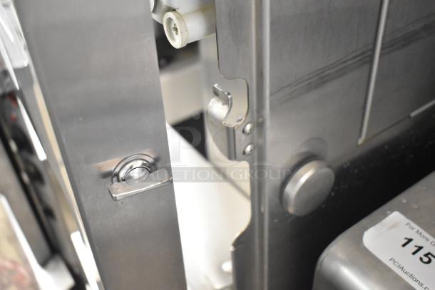 LATE MODEL JBT 2ND-GEN-MFJ-HE commercial citrus juicer, stainless steel, on casters, 120V, with visible label and control details.