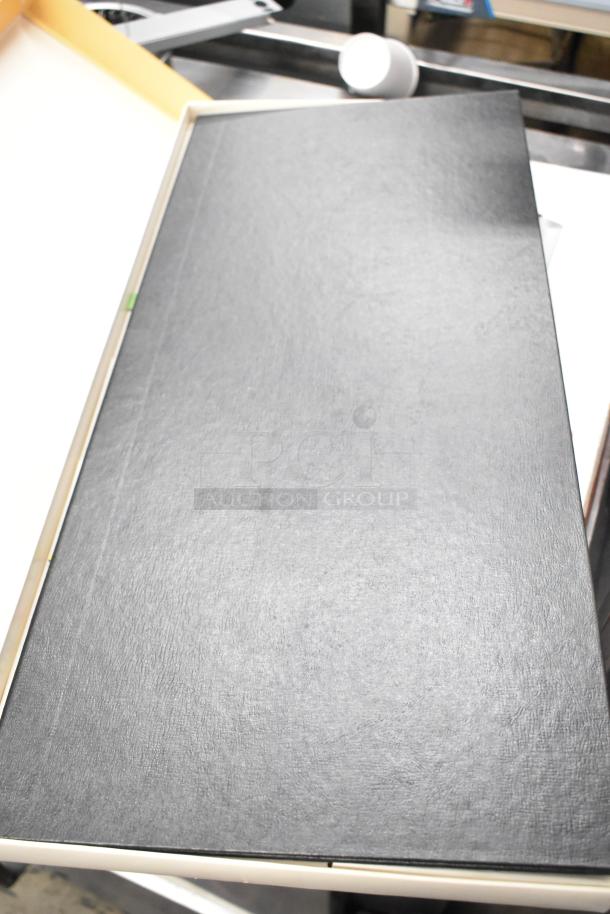 A closed black box in original packaging, possibly containing The Farming Game and Durable Key Box. No visible labels or markings.