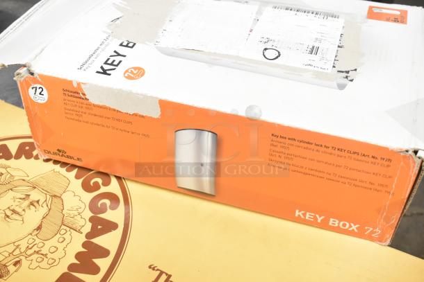 The Farming Game board game and Durable Key Box for 72 key clips, both in original boxes, showing minor wear.