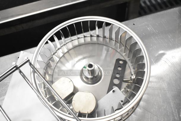 20 various industrial items including metal blower wheel and components, on metallic surface. Items appear new.