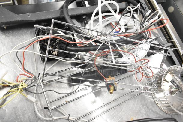 Assorted electrical components and wiring, including ballasts and a blower wheel, in used condition.