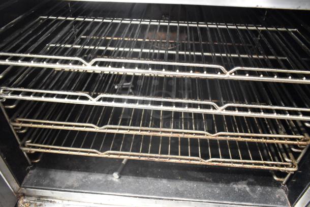 Blodgett commercial full size convection oven interior with view through door, solid door, and multiple racks.