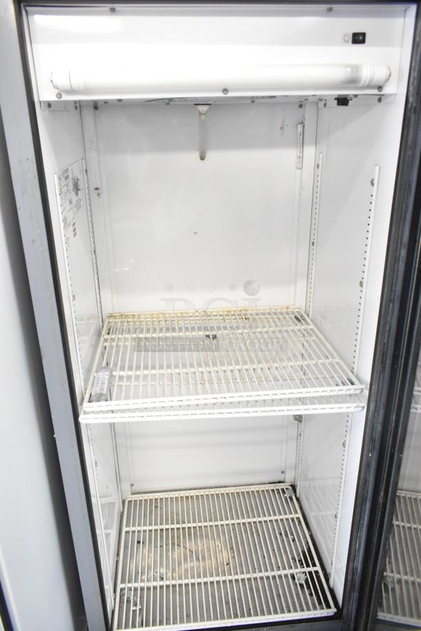 True GDM-12 commercial cooler, single door reach-in, 115 volts, 1 phase, wire shelves, clean interior, some wear visible.