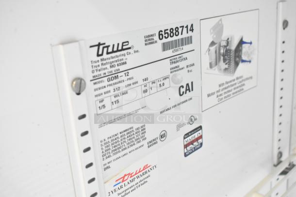 True GDM-12 Commercial Single Door Reach In Cooler. Model: GDM-12, 115V, 1 Phase. Label shows specs and warranty details.