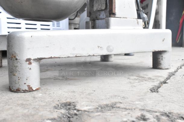 Hobart A120 commercial countertop dough mixer base with visible wear, showing metal legs and partial view of the mixing bowl.