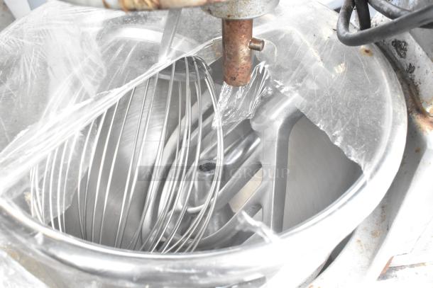 Hobart A120 commercial mixer with 12-quart bowl, whisk, and paddle attachments, 115V, 1 phase. Includes protective wrap.