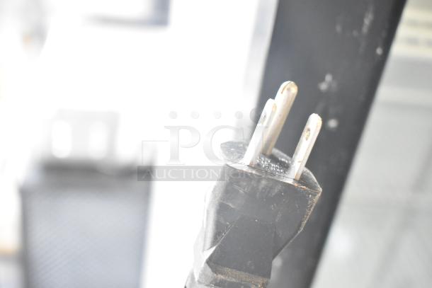 Close-up image of a plug from a 2017 Fetco CBS-2121 Commercial Countertop Drip Coffee Machine, 100-120 Volts, 1 Phase.