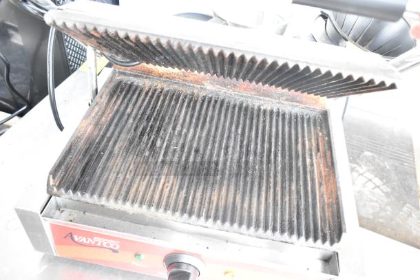 Avantco 177P7B countertop panini press, 120V, 1 phase, visible wear on grill plates, Avantco branding on front panel.