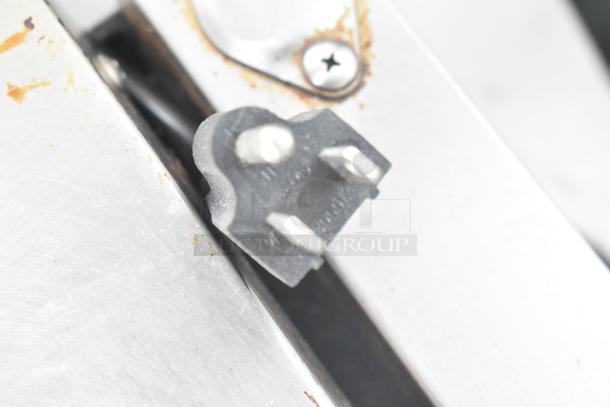 Avantco 177P7B Countertop Panini Press, showing plug and stainless steel detailing, 120V, 1 Phase, in used condition.