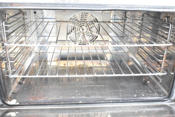 Avantco CO-16 countertop convection oven, 1.5 cu. ft., 120V, interior view, dual racks, visible fan, signs of use.