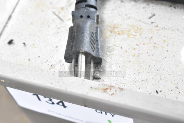 Vevor HT-821 Electric Griddle plug and griddle surface detail, showing 120V connection. Griddle surface appears used, with minor debris.