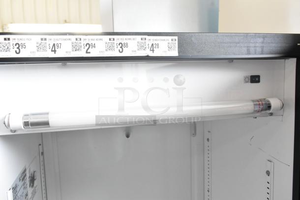 True GDM-12 cooler interior with fluorescent light. Includes product pricing labels. 115 volts, 1 phase.