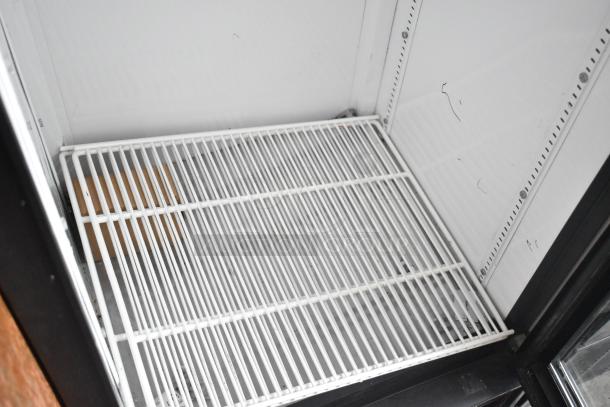 True GDM-12 commercial cooler interior with white wire shelving, single glass door. 115V, 1-phase. Clean, good condition.