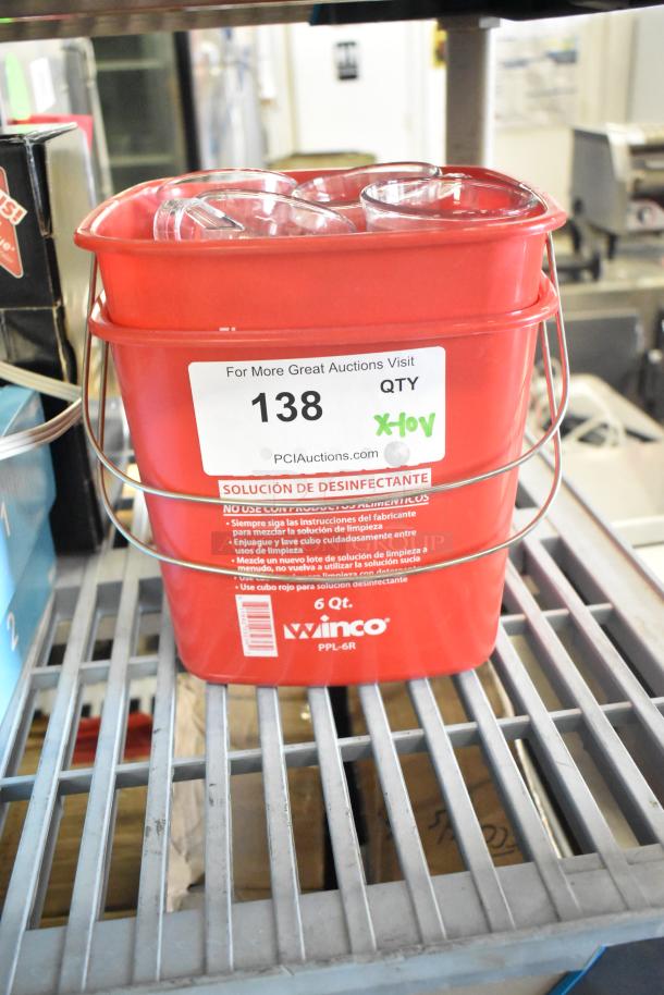 Red poly bucket with metal handle, marked "Winco" and "6 Qt," includes clear poly pitchers inside. Auction lot sticker "138."