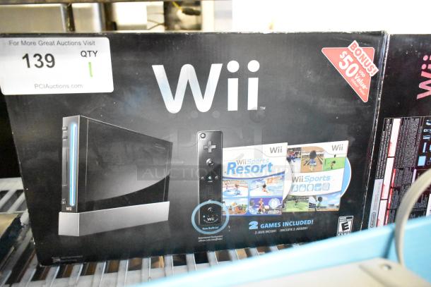 Nintendo Wii console in original box, 115 volts, includes Wii Sports and Wii Sports Resort games, bonus $50 value.