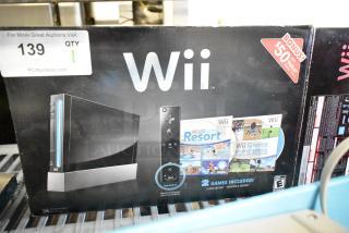 Nintendo Wii console in original box, 115 volts, includes Wii Sports and Wii Sports Resort games, bonus $50 value.