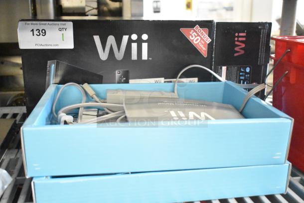 Nintendo Wii console in original box with cables; 115 Volts, bonus $50 value offer on box.