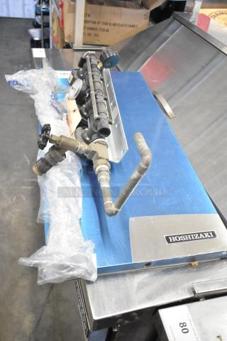 3 various items: Everpure 4000 water filter head, CL40FC-B Marinco power cap, Hoshizaki ice machine door, on display table.