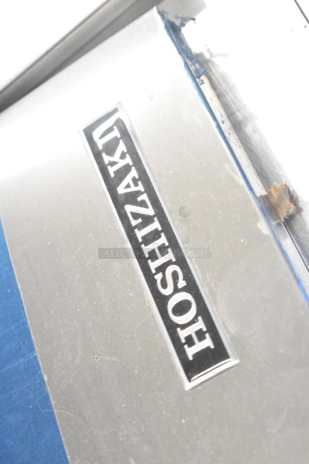 Hoshizaki ice machine door with brand label, shown in metal condition. Part of auction lot with additional items.