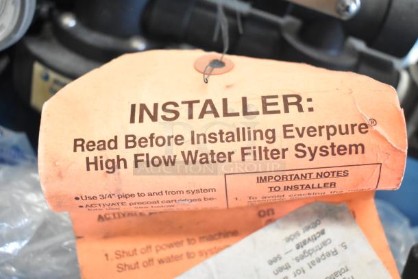 Orange tag with instructions for installing the Everpure High Flow Water Filter System, detailing important steps and notes.